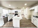 Bright kitchen featuring white cabinetry, stainless steel appliances and a center island at 7329 Cogburn St, Las Vegas, NV 89131
