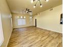 Spacious living room featuring luxury vinyl flooring, neutral walls and modern lighting at 7329 Cogburn St, Las Vegas, NV 89131