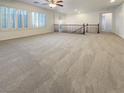 Spacious living room area with large windows and neutral carpeting at 7719 Windy Meadow Ave, Las Vegas, NV 89178