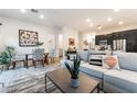 Bright open-concept living space features modern decor, dining area, and seamless flow to the kitchen at 905 Belleforte Ln, Las Vegas, NV 89138