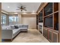 Inviting living room with a large sectional couch, multiple screens, and a fireplace at 9103 Alta Dr # 102, Las Vegas, NV 89145