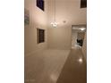 Bright living room features soaring ceilings, tile floors, and an elegant chandelier at , Las Vegas, NV 89148