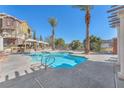 Inviting community swimming pool with clear blue water, palm trees, sun loungers, and cabanas for relaxation at 1 Corte Belleza, Henderson, NV 89011