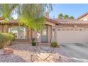 Inviting home exterior featuring desert landscaping and a stone walkway to the entrance at 10113 Walhalla Plateau Ct, Las Vegas, NV 89148