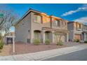 Charming two-story home features desert landscaping, a tile roof, and an attached two-car garage at 10306 Coastline Creek Ct, Las Vegas, NV 89141
