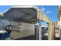 Close-up of open-sided carport with items stored, showing utilitarian outdoor covered space at 17 Mallory St, Henderson, NV 89015