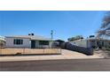 Exterior view of two homes with a carport between them, featuring low-pitched roofs at 17 Mallory St, Henderson, NV 89015