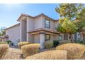 Exterior view of the condo building with well-manicured bushes and a desert landscape design at 2606 S Durango Dr # 232, Las Vegas, NV 89117