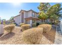 Angle view of the condo building exterior featuring a tile roof and well-manicured desert landscaping at 2606 S Durango Dr # 232, Las Vegas, NV 89117
