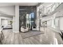 Modern foyer featuring a dramatic spiral staircase, large windows and stylish decor at 2818 E Quail Ave, Las Vegas, NV 89120