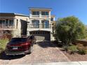 Charming two-story home featuring a paved driveway, a well-maintained lawn, and a two-car garage at 7068 Parrot Bay Way, Las Vegas, NV 89118