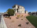 Spacious yard with xeriscape landscaping and a freshly cut lawn at 7068 Parrot Bay Way, Las Vegas, NV 89118