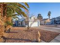 Single-story home showcasing a xeriscape front yard and mature landscaping at 8072 Big Top Dr, Las Vegas, NV 89123