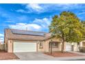 Inviting single-story home featuring neutral tones, solar panels, and an attached two-car garage at 904 Melic Way, North Las Vegas, NV 89032