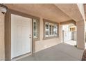 Inviting front porch area with a white door and trim, offering a welcoming entrance to the home at 904 Melic Way, North Las Vegas, NV 89032