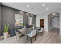 Dining area showcases modern table and chairs with elegant wall decor and adjacent doorway at 9101 Alta Dr # 11, Las Vegas, NV 89145