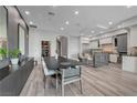 The dining area features a modern table and chairs, accented by stylish wall decor, and an open view to the kitchen at 9101 Alta Dr # 11, Las Vegas, NV 89145