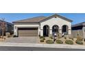Charming single-story home with a two-car garage, paver driveway, and drought-tolerant landscaping at 10064 Ocher Valley Ave, Las Vegas, NV 89178