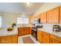 Well-lit kitchen featuring light wood cabinetry, white countertops, and stainless steel appliances at 1016 Wannamaker Way, Henderson, NV 89015