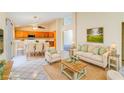 Open-concept living room flows into the dining area, creating a comfortable and inviting space at 1016 Wannamaker Way, Henderson, NV 89015