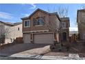 Beautiful two-story home featuring a paved driveway, two-car garage and desert landscaping at 10511 Loma Portal Ave, Las Vegas, NV 89166