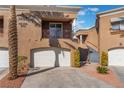 Stylish townhome showcases dual balconies and attached garages in a landscaped setting at 1405 San Juan Hills Dr # 104, Las Vegas, NV 89134