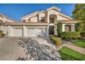 Stunning two-story home with a three-car garage, tile roof, and meticulously maintained landscaping at 174 Buena Ct, Henderson, NV 89074