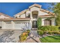 Beautiful two-story home with a three-car garage, tile roof, and manicured front yard at 174 Buena Ct, Henderson, NV 89074