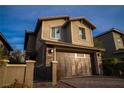 Inviting two-story home featuring stone details and a spacious two-car garage, creating a warm curb appeal at 343 Cadence Vista Dr, Henderson, NV 89011