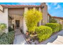 Exterior view of landscaped front entrance with security gate and red tile roof at 3990 Camas Ct, Las Vegas, NV 89103