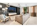 Modern living room with stylish decor, geometric wall and a large screen TV at 4650 Wonderful St, Las Vegas, NV 89147