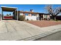 Street view of single-story home with covered parking and minimal landscaping at 4964 Dunkirk Ave, Las Vegas, NV 89121