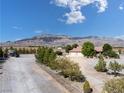 An aerial view of a desert home showcasing the large lot, mountain views and surrounding landscape at 5090 N David St, Pahrump, NV 89060