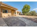 Exterior shot of a home with a stone pathway leading to a column-lined covered porch at 5090 N David St, Pahrump, NV 89060
