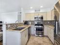 Well-equipped kitchen features granite countertops, stainless steel appliances, and tile flooring at 5092 Mandalay Springs Dr # 201, Las Vegas, NV 89120