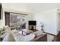 Comfortable living room with plush sofa and balcony access, perfect for relaxing and entertaining at 5092 Mandalay Springs Dr # 201, Las Vegas, NV 89120