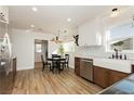 Bright kitchen featuring white cabinets, a farmhouse sink, and stainless steel appliances at 525 Date St, Boulder City, NV 89005