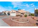 Tan single-story home with desert landscaping and a blue sky at 6224 Mandarin Dr, Las Vegas, NV 89108