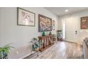 Bright foyer with wood-look tile flooring, decorative console, and artwork on the neutral walls at 6461 Mount Eden Ave, Las Vegas, NV 89139