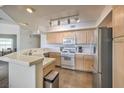 Functional kitchen features tile countertops, modern appliances, and ample cabinet space at 6909 Cobre Azul Ave # 202, Las Vegas, NV 89108