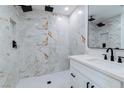 Modern bathroom featuring double shower heads and marble tile at 724 6Th St, Boulder City, NV 89005