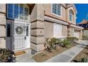 Close-up of the front entrance featuring a decorative wreath, sidelight windows, and a welcoming doormat at 7624 Nocturne Ct, Las Vegas, NV 89128