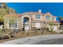 Inviting two-story home featuring a red tile roof, desert landscaping, and a bright and airy facade at 7624 Nocturne Ct, Las Vegas, NV 89128