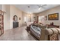 Bright living room with neutral walls, tile flooring and comfortable seating at 8233 Valley Stream Ave, Las Vegas, NV 89131