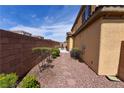 Private backyard featuring a stone-lined walkway and a seating area for outdoor enjoyment at 8376 Rygate Ave, Las Vegas, NV 89178