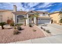 Beautiful two-story home boasting a well-manicured front yard and a spacious three-car garage at 13 White Tail Ct, Henderson, NV 89074