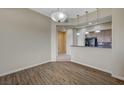 Wood floor dining area open to kitchen with pendant lights and stainless steel appliances at 20 E Serene Ave # 304, Las Vegas, NV 89123