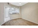 Open concept living room showing the kitchen with white cabinetry and granite counters at 20 Serene Ave # 201, Las Vegas, NV 89123