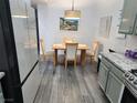 Dining area with modern grey-toned cabinets, stainless appliances and wood-look flooring at 2052 Jade Creek St # 202, Las Vegas, NV 89117
