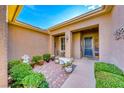 Inviting front patio area with seating, potted plants, and a decorative exterior paint scheme at 2069 King Mesa Dr, Henderson, NV 89012